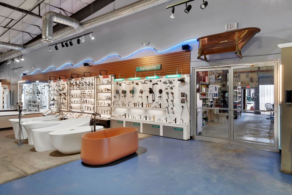 Modern retail showroom interior with sleek display fixtures and bright lighting showcases bathroom fixtures and decor.