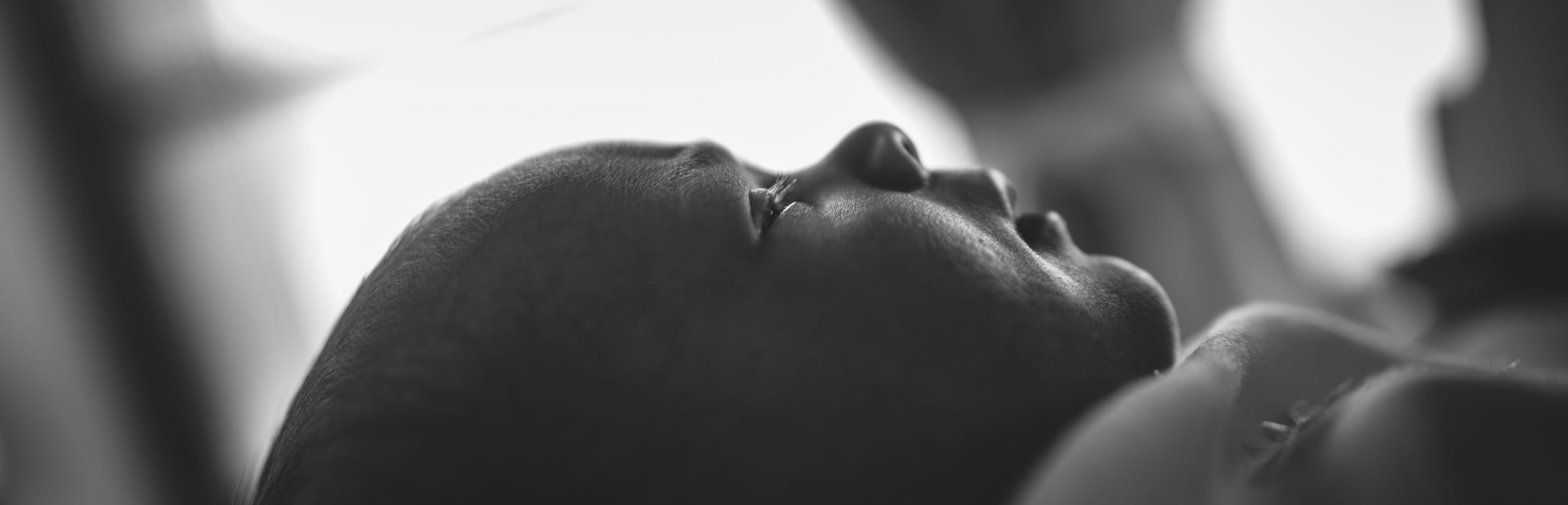 Silhouetted figures embracing in black and white photograph.