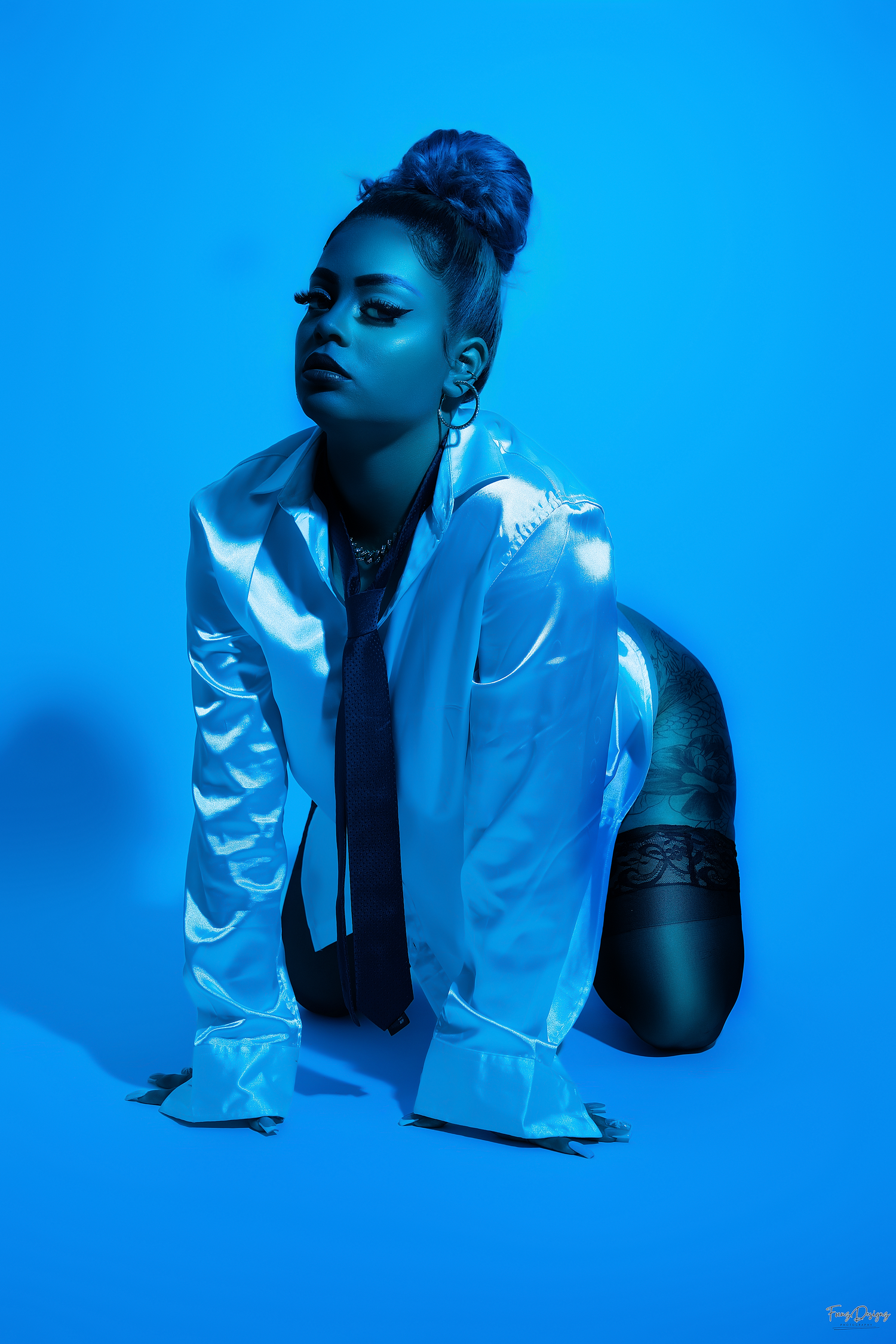Artistic fashion portrait series against vibrant blue background showing dramatic poses in white clothing.