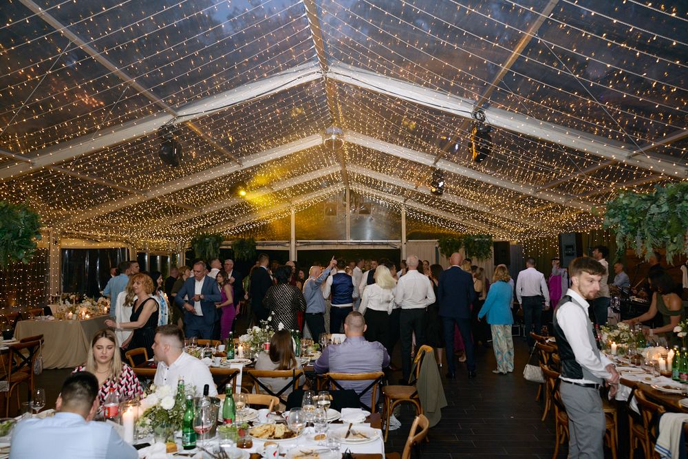 Wedding reception venue decorated with twinkling string lights creating a magical atmosphere.