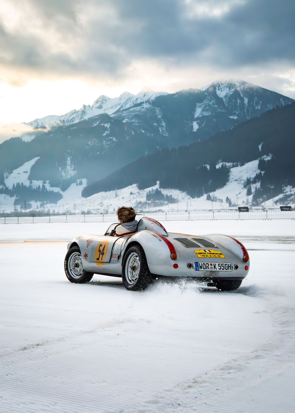 image of classic Porsche car driving on snow at the FAT Ice Race in Austria.