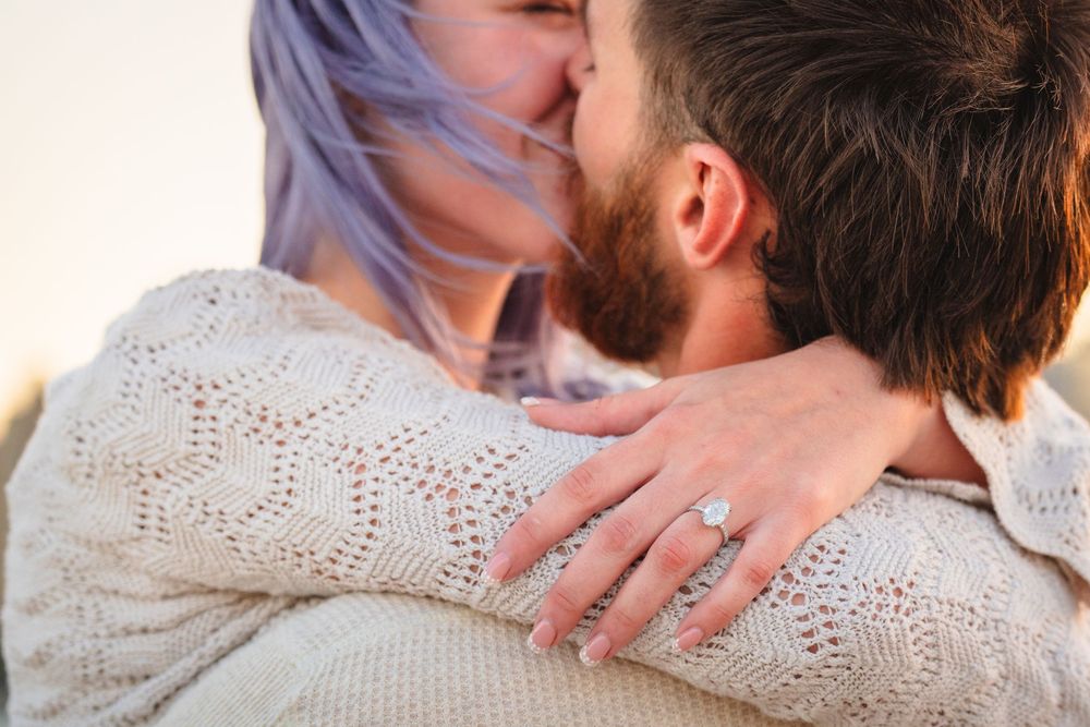 An intimate moment captured in warm sunlight with soft focus and gentle embrace.