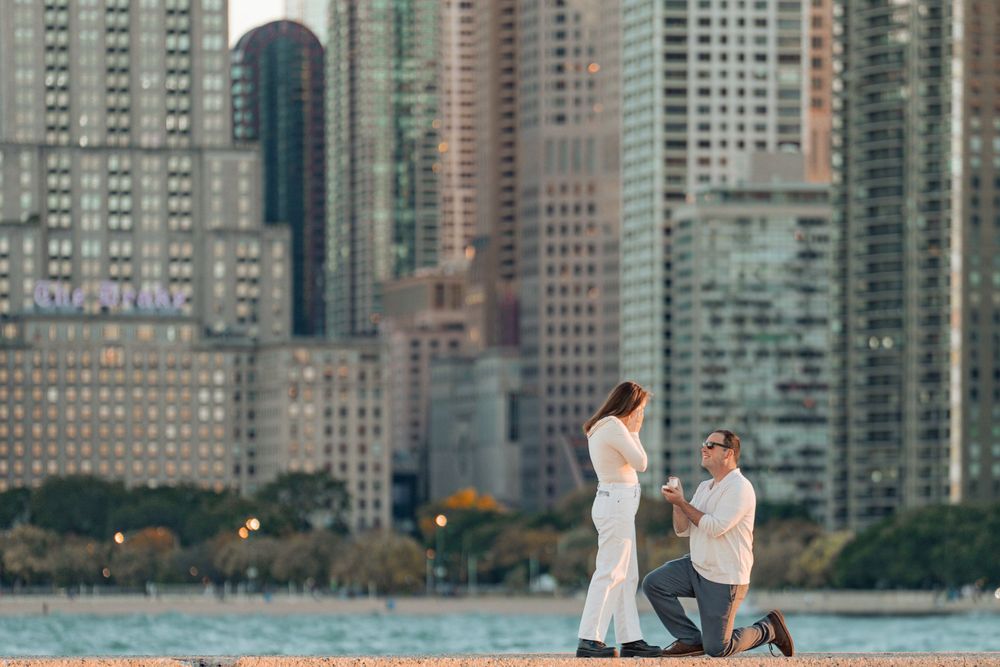 Urban proposal scene against Chicago's waterfront skyscrapers during golden hour.