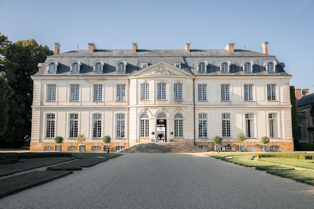 Grand French chateau with classic architecture and symmetrical design featuring multiple dormer windows.