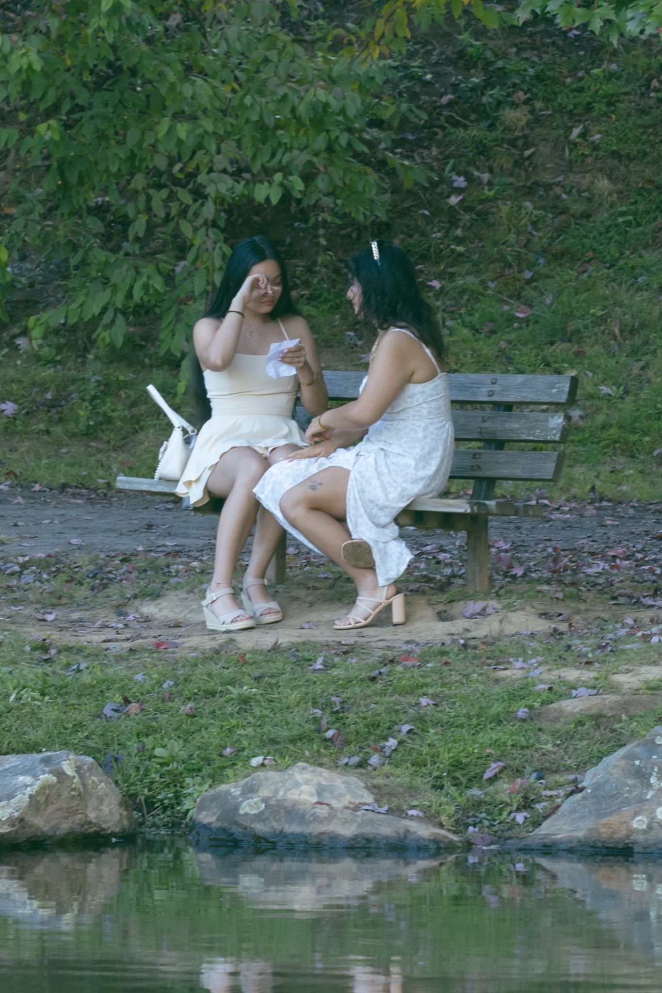 LGBTQ couple holding hands after romantic proposal at blue ridge mountain overlook near Asheville, North Carolina