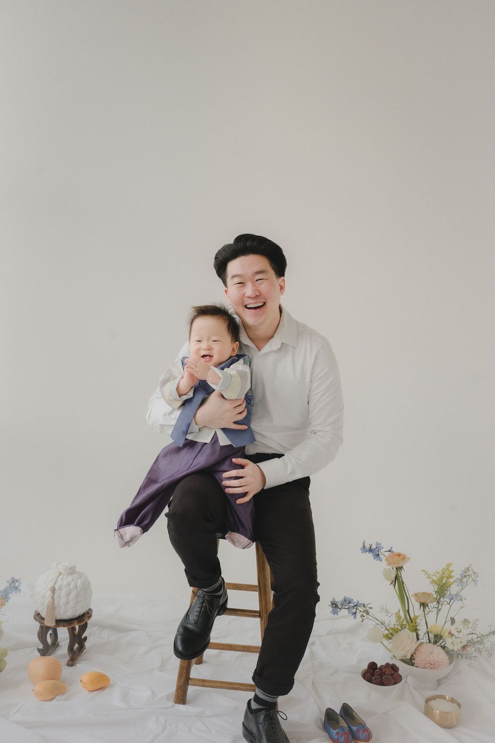 Three minimalist studio portraits featuring joyful moments between parent and child against a light gray background.