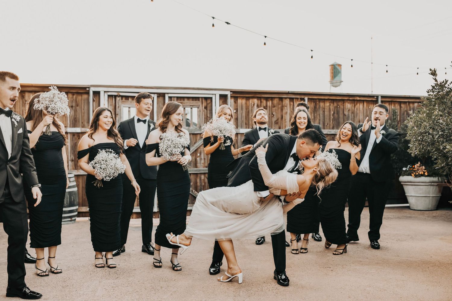 Candid sunset portraits of wedding party walking and laughing, editorial movement-focused imagery at Brake & Clutch Warehouse