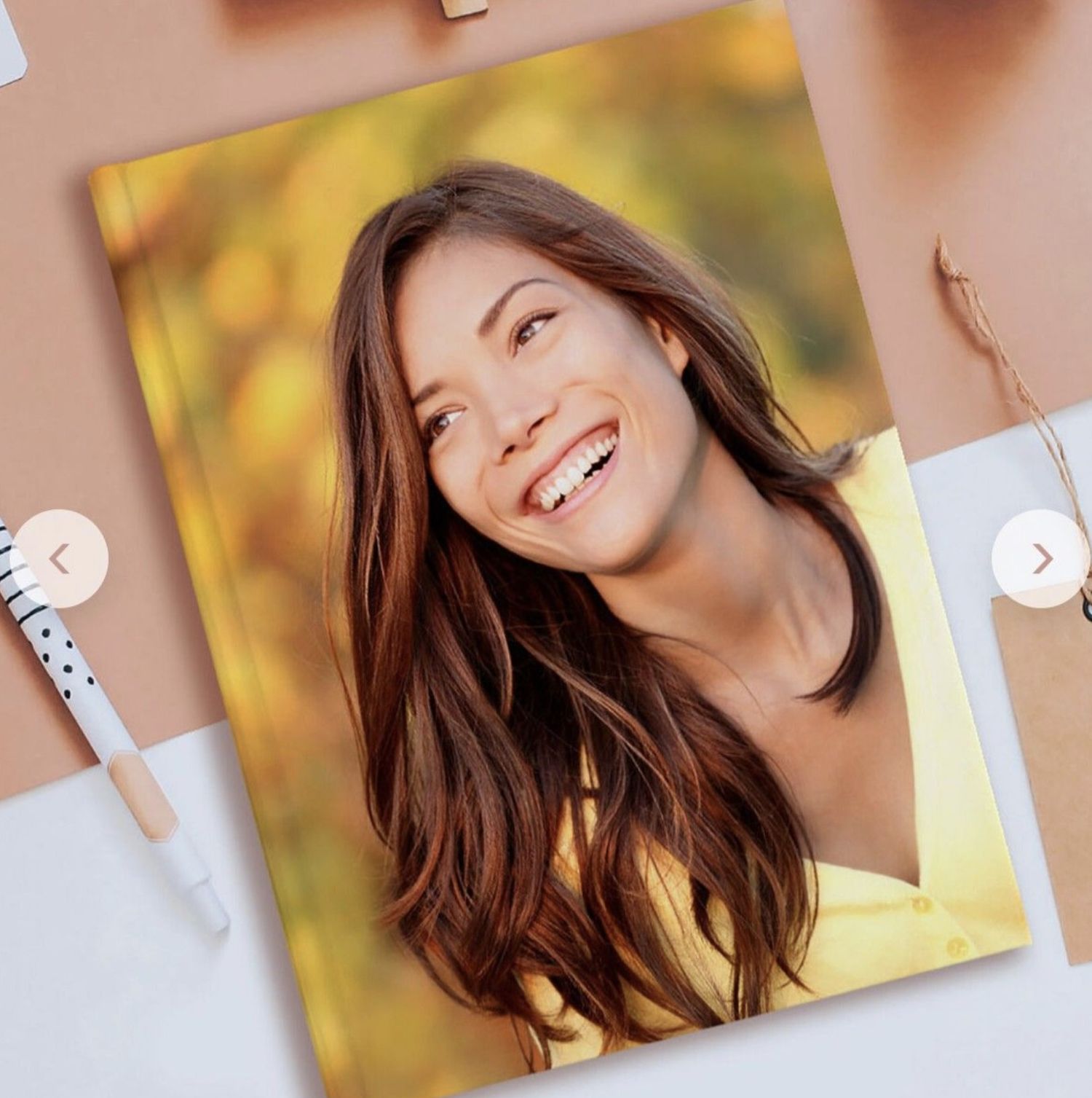 Smiling woman on the cover of a custom photo notebook with a printed image. Vivitu photo gift.