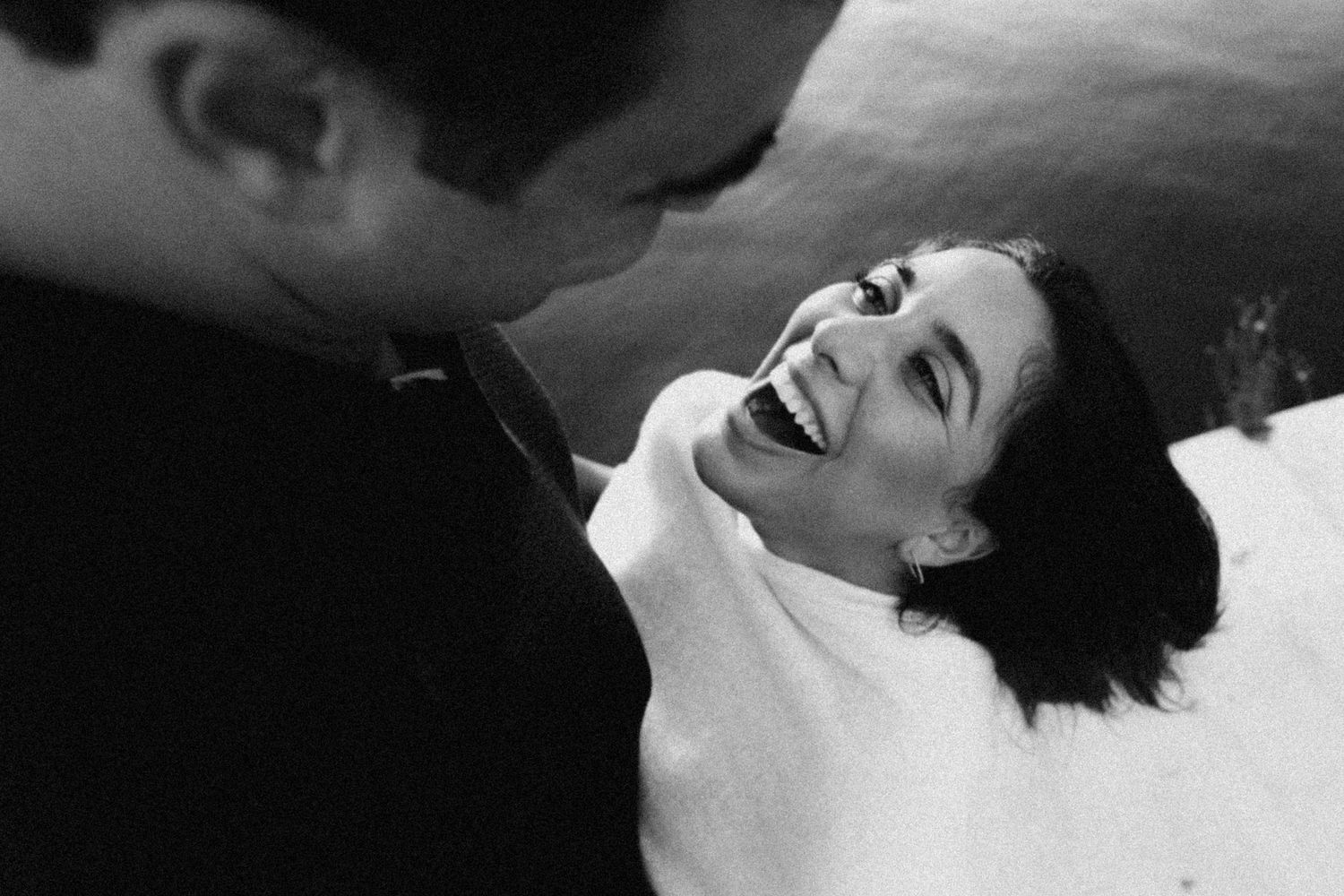 Seven black and white close-up photos showing intimate moments of emotion and laughter.