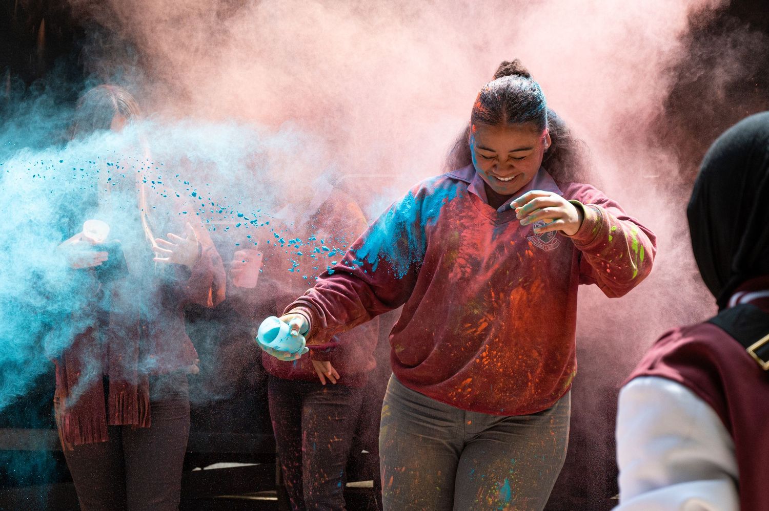 Girl throwing paint at Holi Hai Festival in south Eveleigh, Sydney.