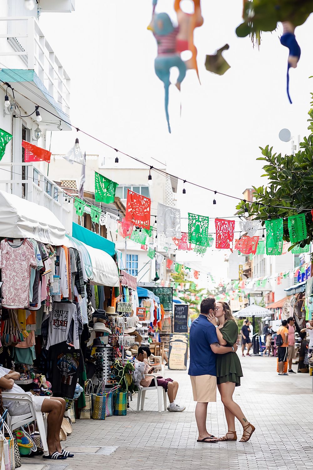 Romantic street session in Isla Mujeres with colorful murals and windows.