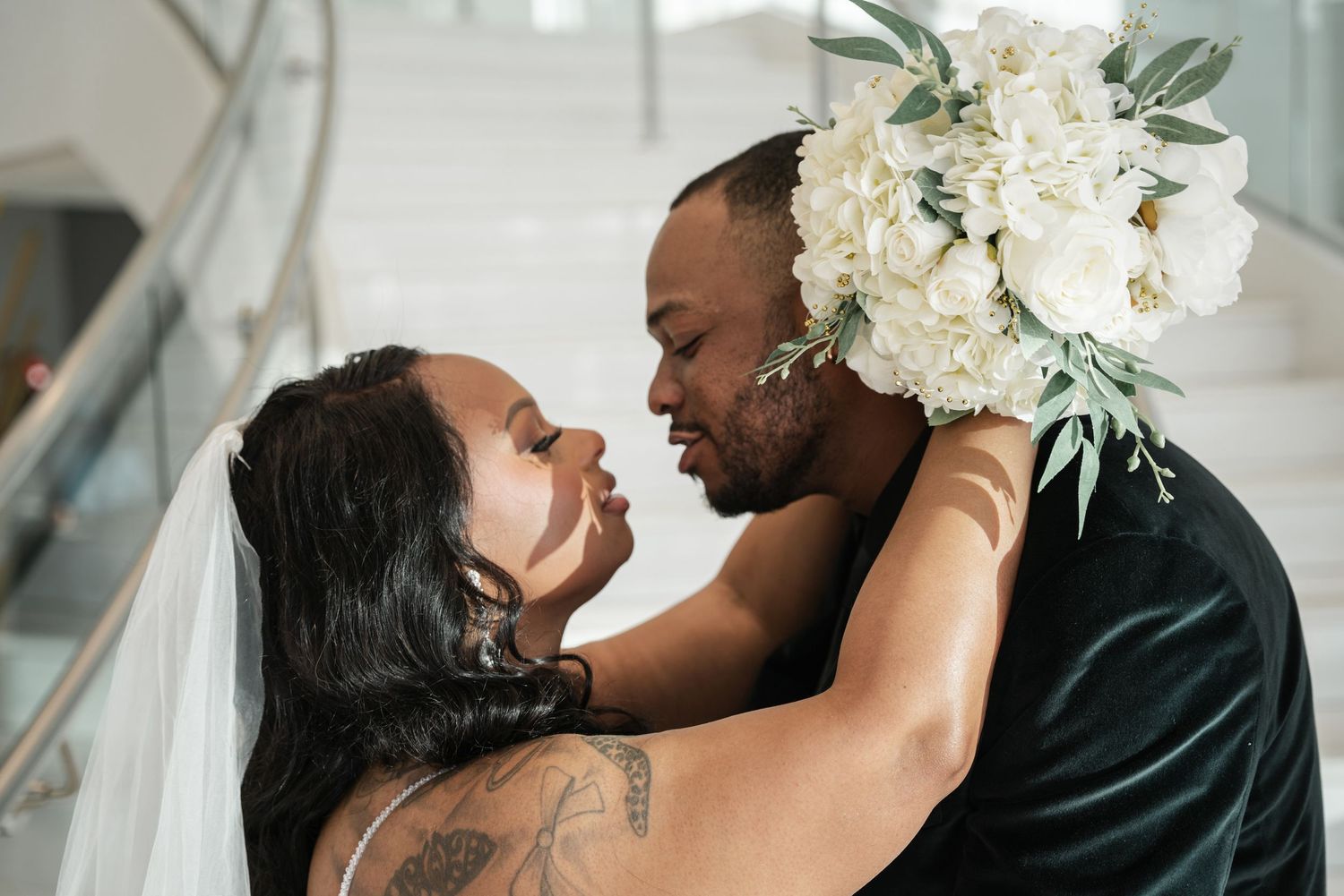 A romantic wedding couple sharing intimate kisses in a series of elegant black and white and color photographs.
