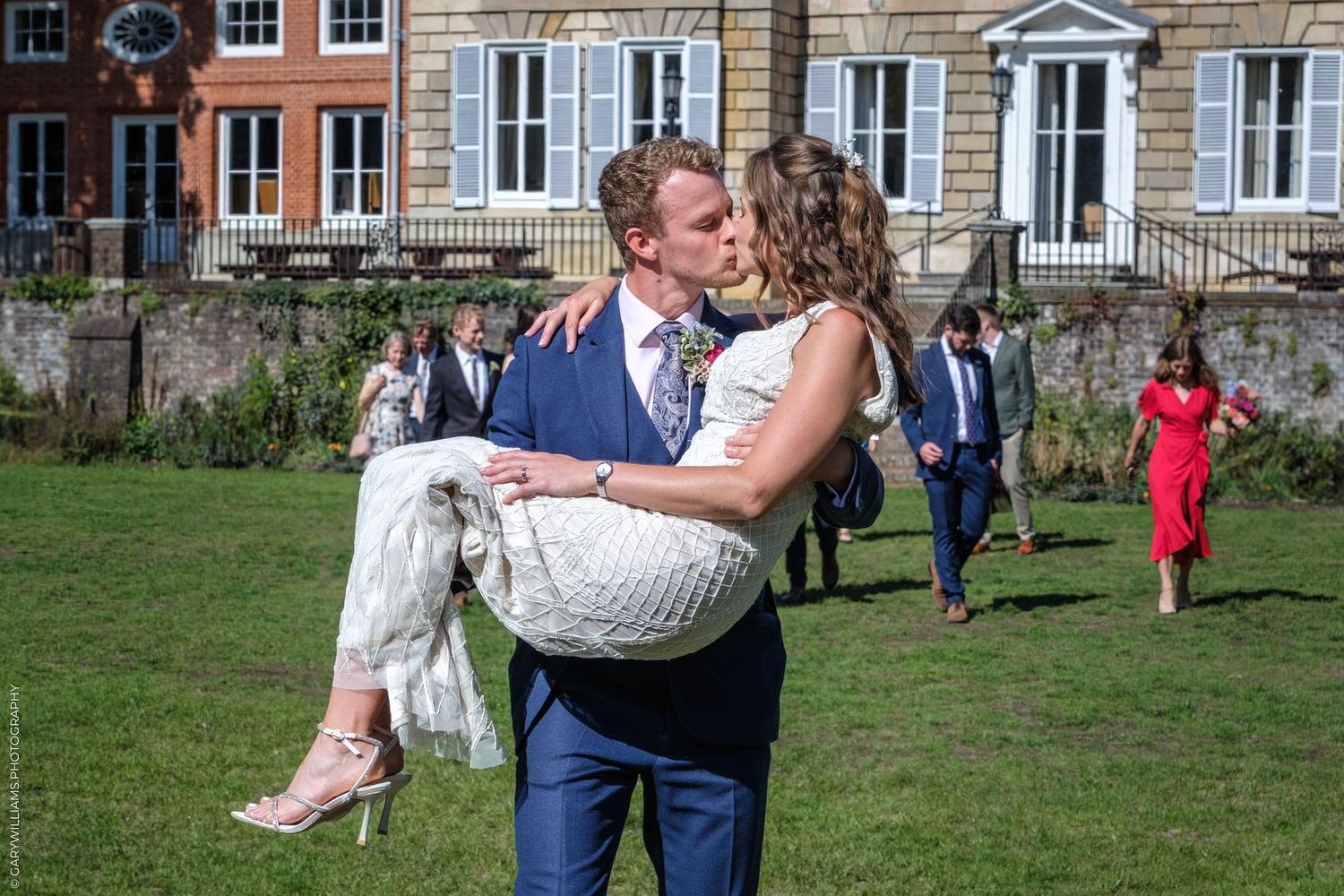 Newlywed couple shares a romantic dance sequence in an outdoor garden setting with guests watching in background.