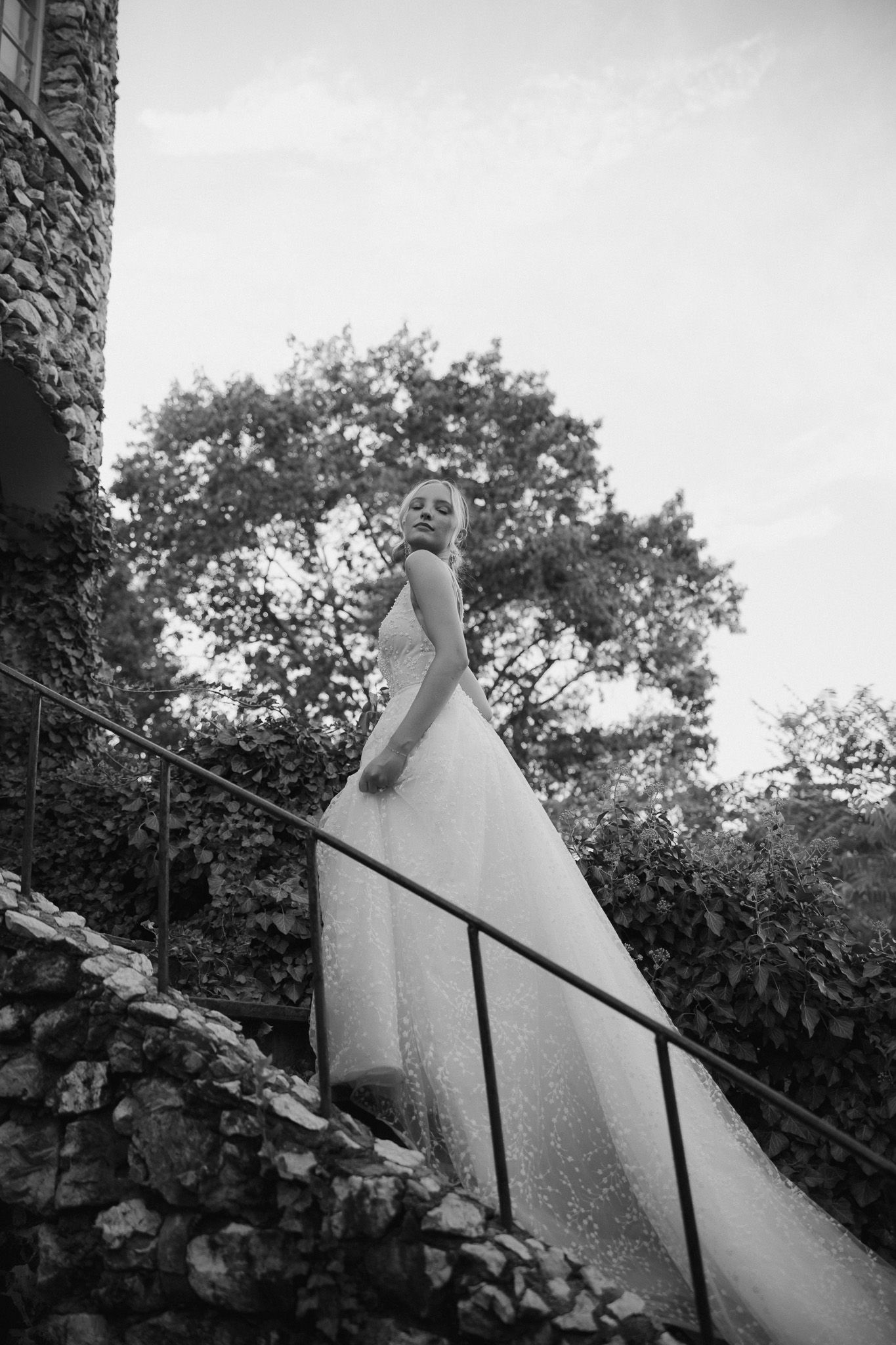A minimalist black and white architectural detail shows angled white walls against trees in a geometric composition.