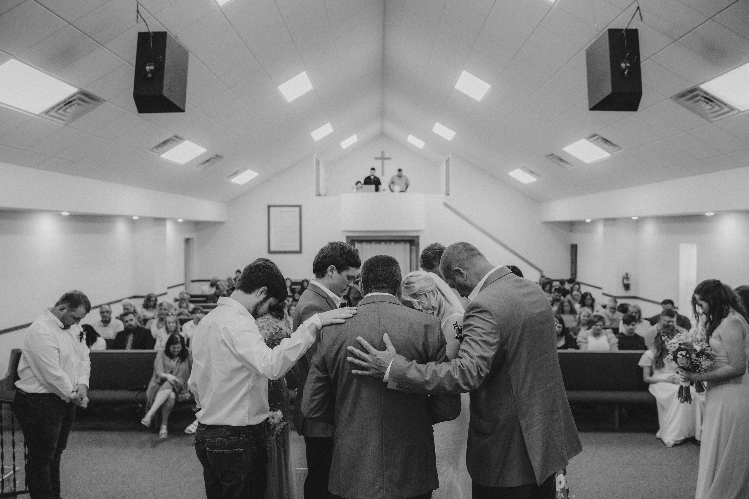Wedding couples dance together in a large reception hall during a traditional first dance lesson.