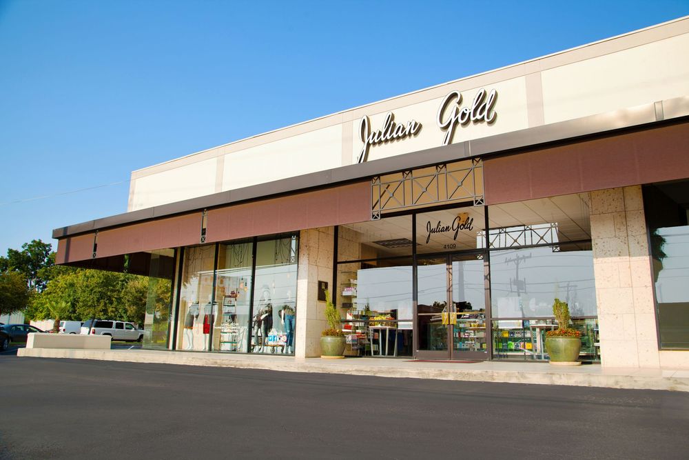 Exterior view of a Southern Gold retail storefront with beige facade under blue sky.