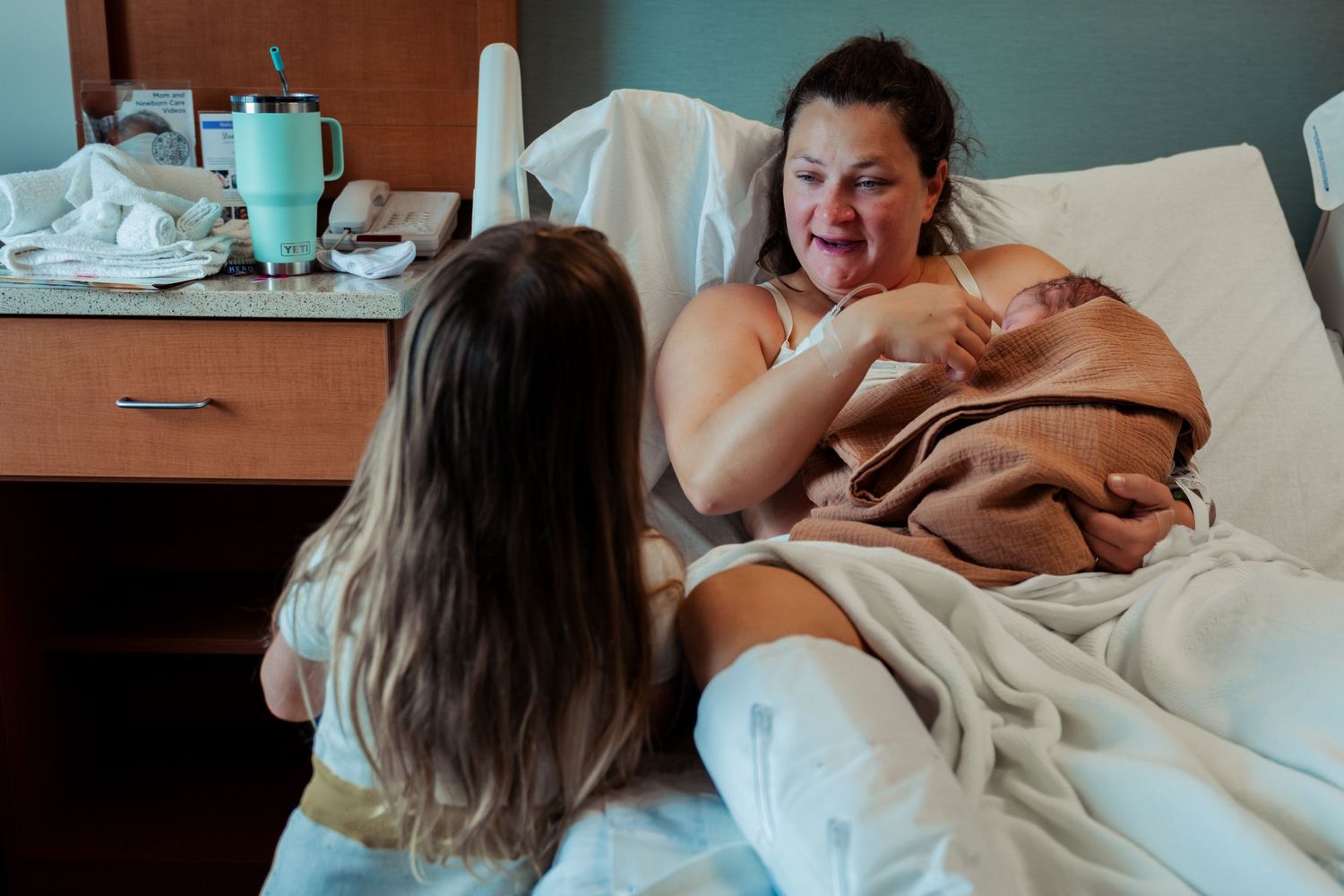 New mom holding baby during Fresh 48 hospital session at Oschner Baptist in New Orleans