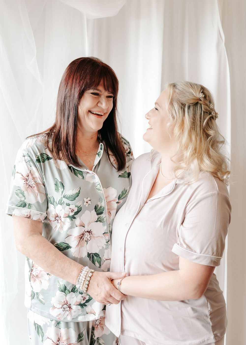 Candid shots show joyful interaction between two people in floral and light colored outfits.
