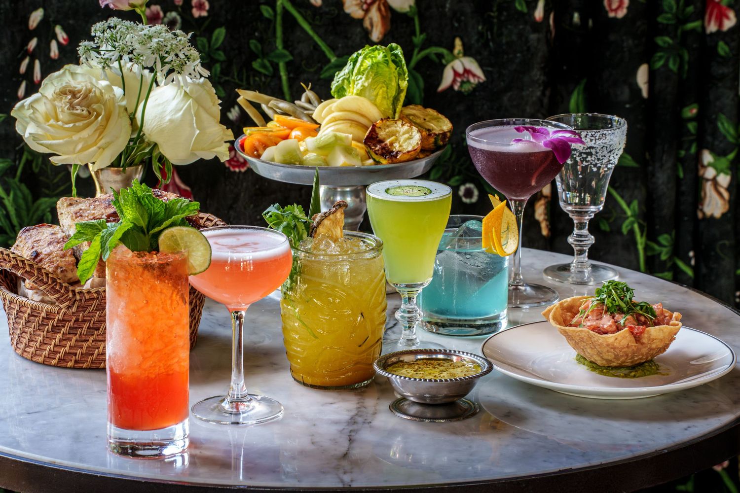 A vibrant Commodore Perry green cocktail served in an elegant coupe glass with garnish sits on a rustic dark table.