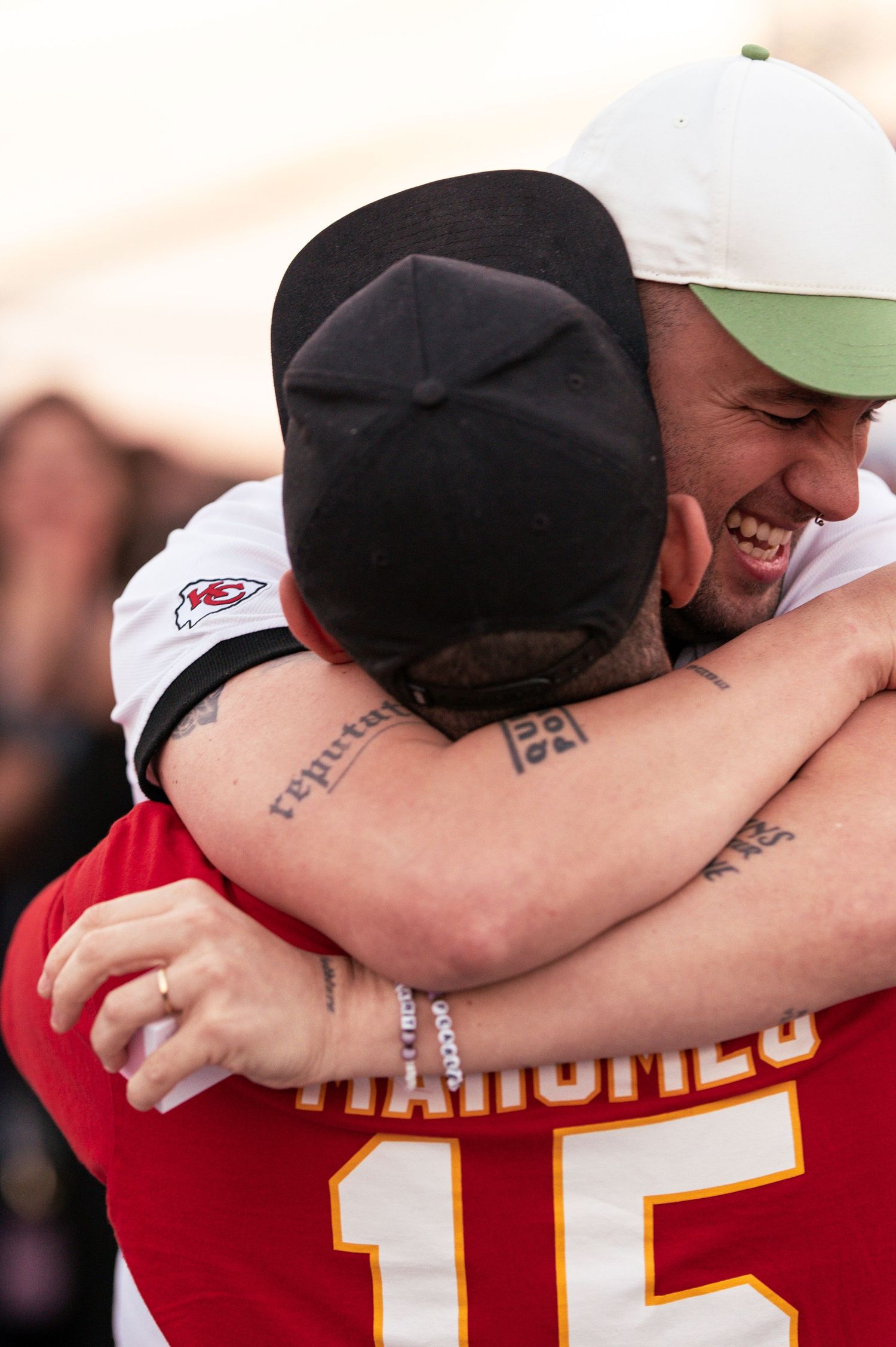 Close embrace between two sports fans shows visible emotion during celebration.