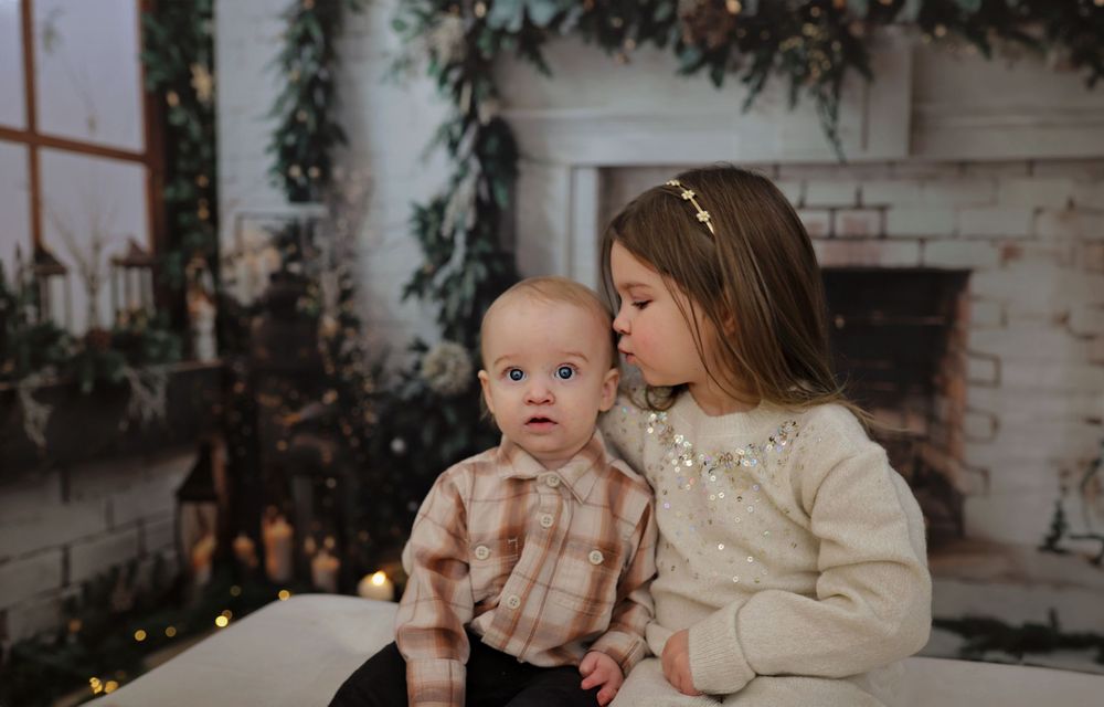 Holiday family photoshoot with cozy winter decor and soft lighting.