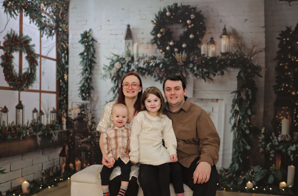 A collection of candid family moments captured against a white wall with festive holiday decorations.