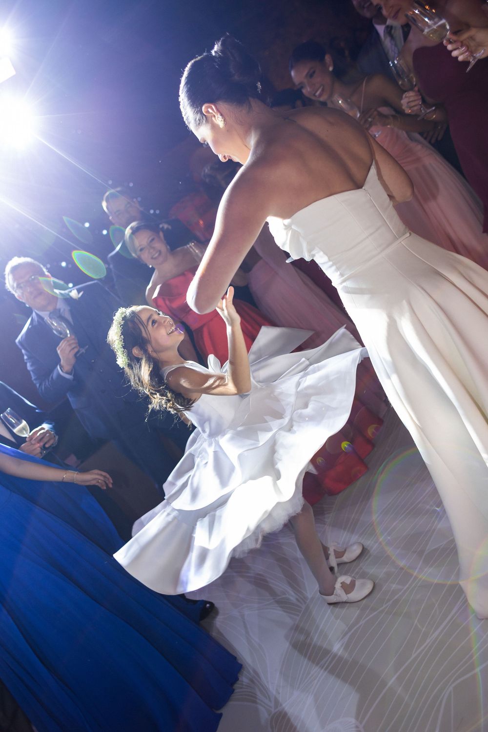 Dancers in formal attire twirling on a brightly lit ballroom floor during an elegant evening celebration.