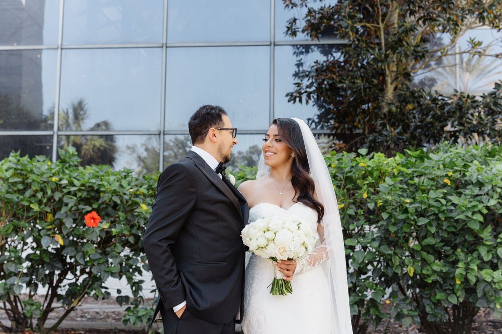 Wedding couple shares intimate moments in a lush garden setting during their romantic outdoor photoshoot.
