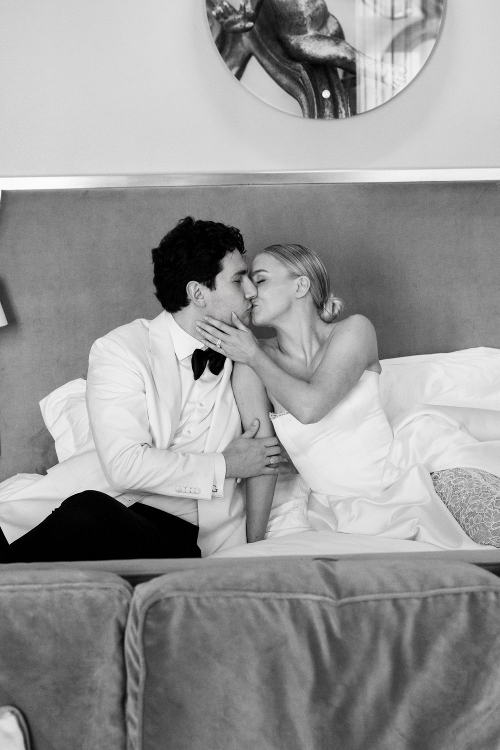 A romantic black and white photo series showing a couple sharing intimate moments while lying in bed together.