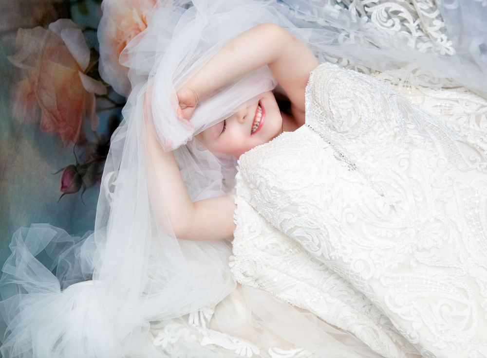 Artistic series showing flowing white lace dress details against a romantic floral background.