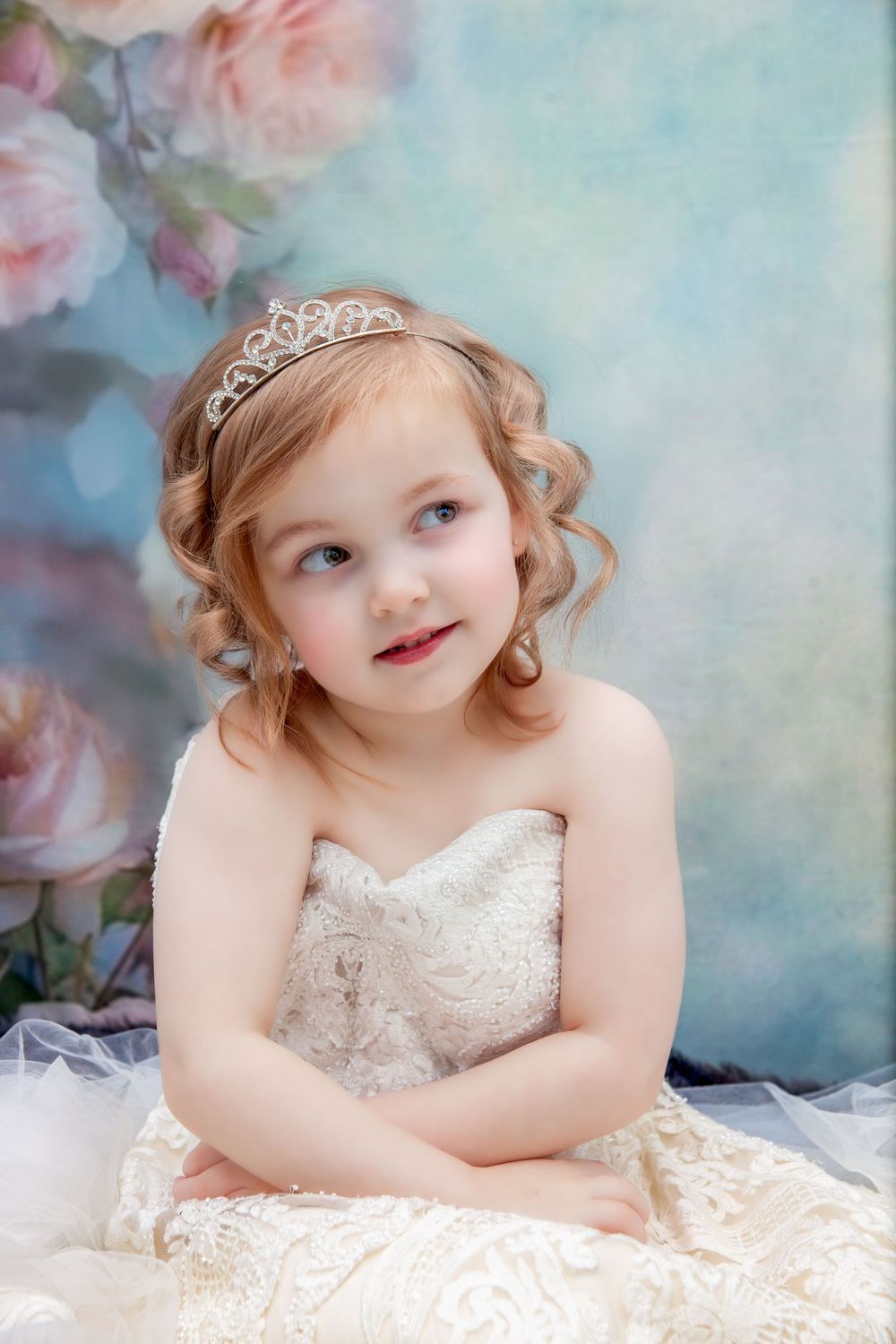 Ethereal studio portrait with soft pastel backdrop and delicate lace details.
