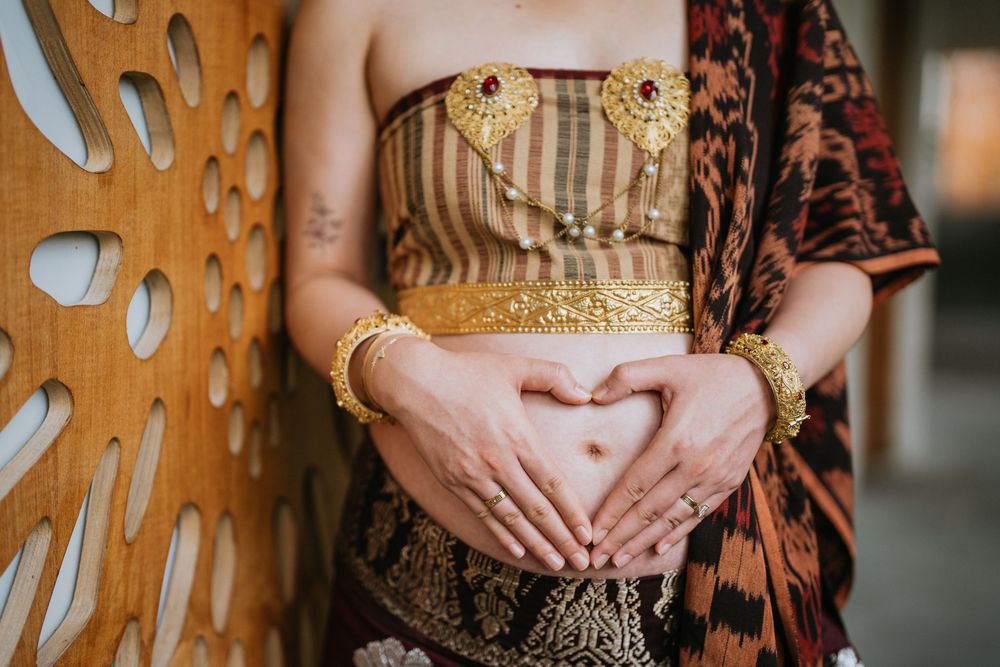 Detail shot of traditional Indonesian ceremonial dress with gold embellishments.