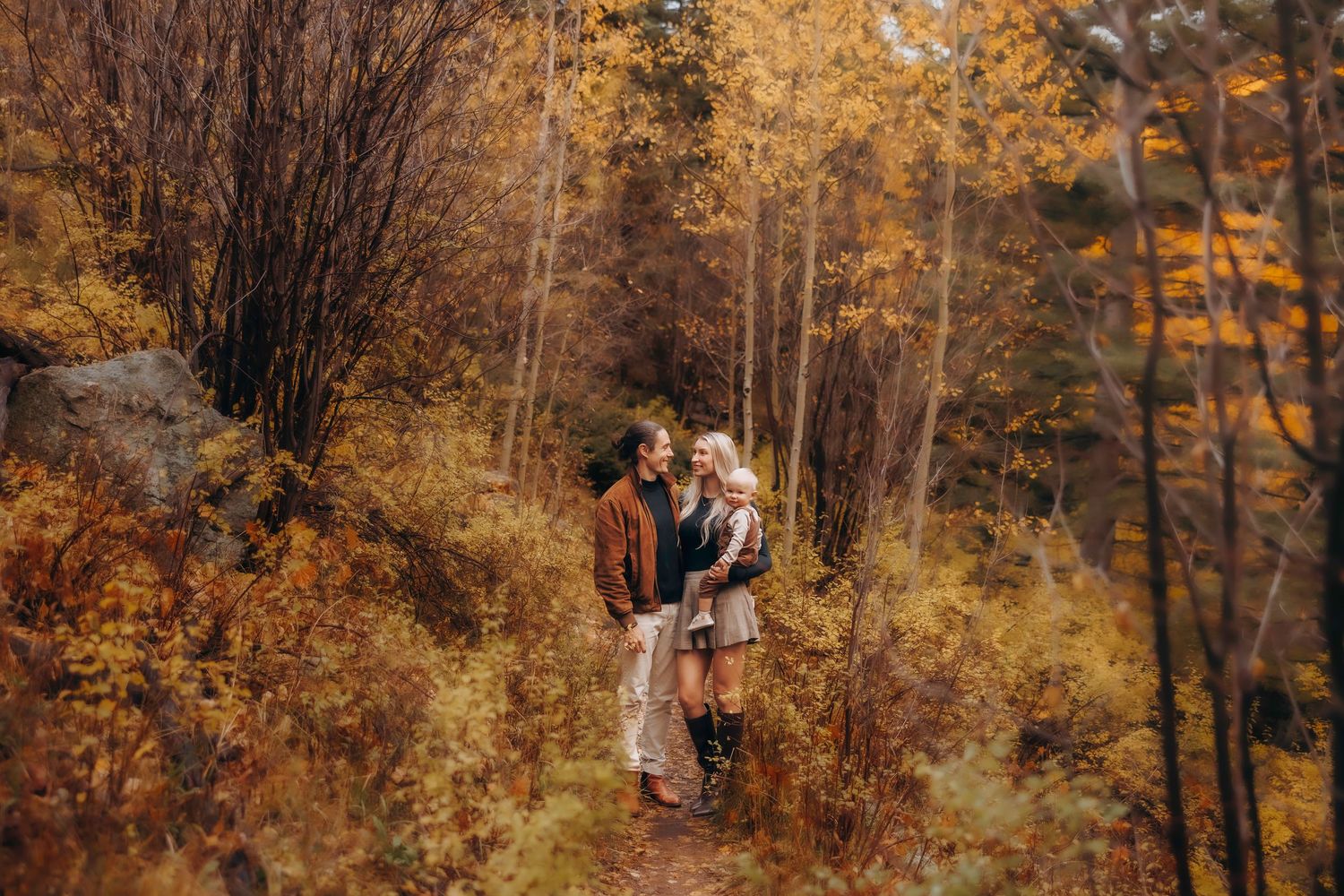 Santa Fe maternity session, white dress stands in scenic Diablo Canyon valley at golden hour.