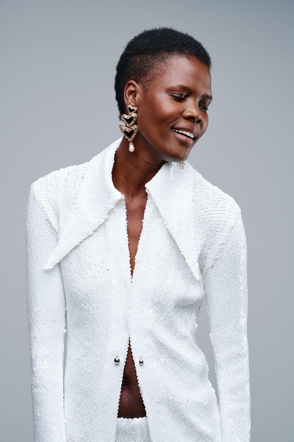 Fashion portrait series showing a white textured jacket styled against a light background.