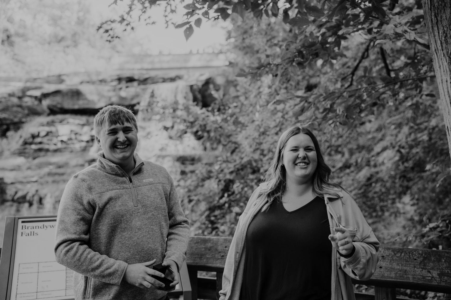 Romantic proposal sequence overlooking cascading Brandywine falls on nature trail for surprise engagement photo session, Ohio
