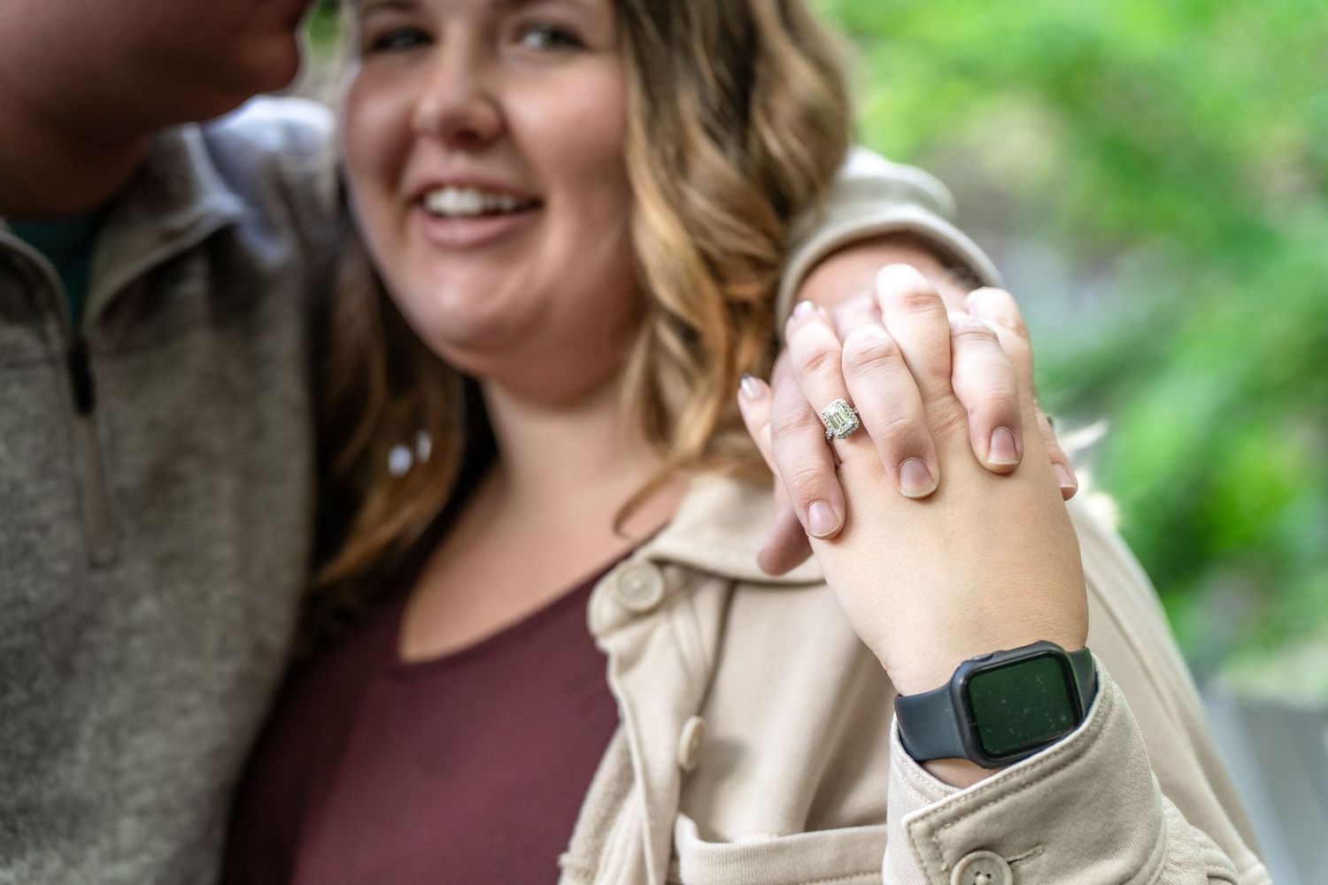 Couple holding hands and smiling during outdoor engagement photography session at Brandywine Falls in Ohio.