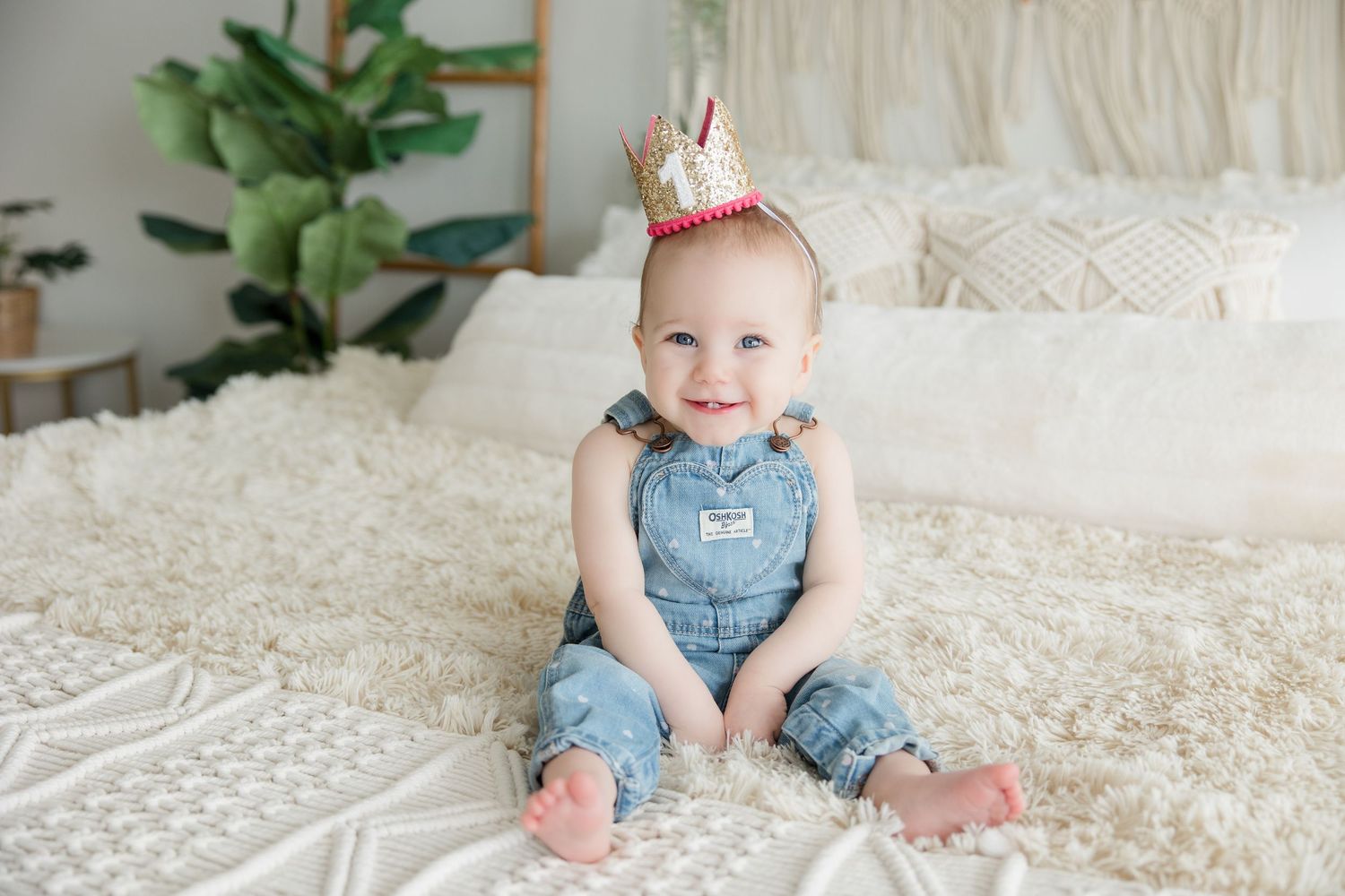 A sequence of baby photos showing little feet and denim overalls on a white textured bedspread.