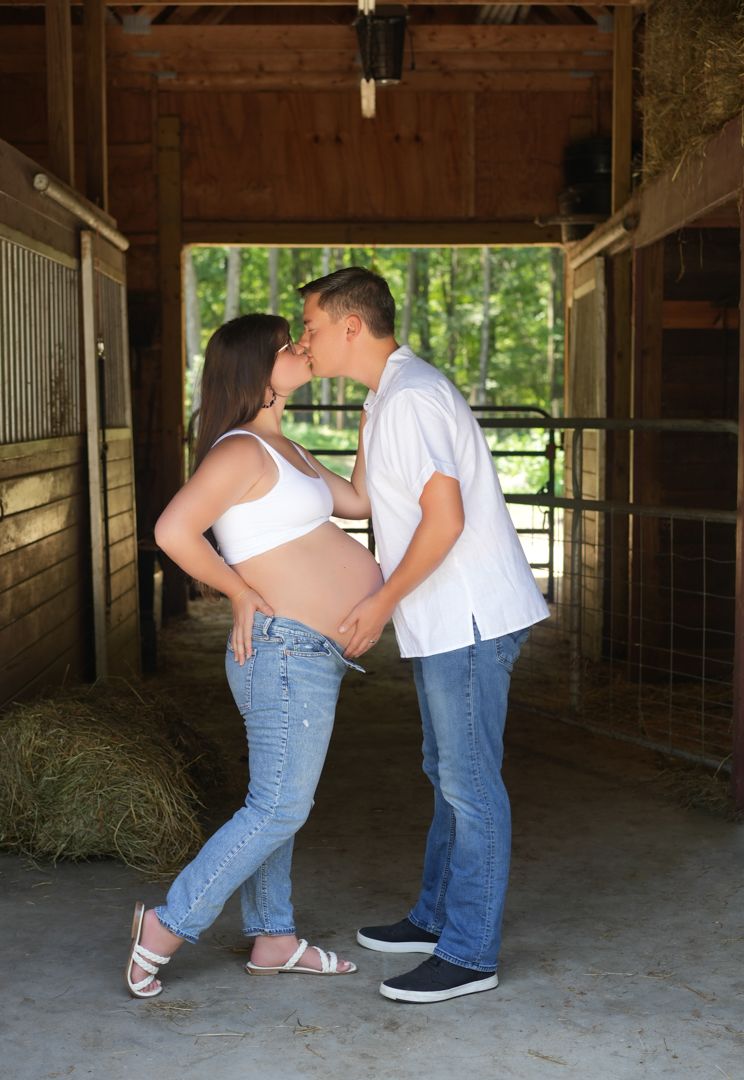 Two people in jeans demonstrate country line dance moves in sequence inside a rustic barn setting.