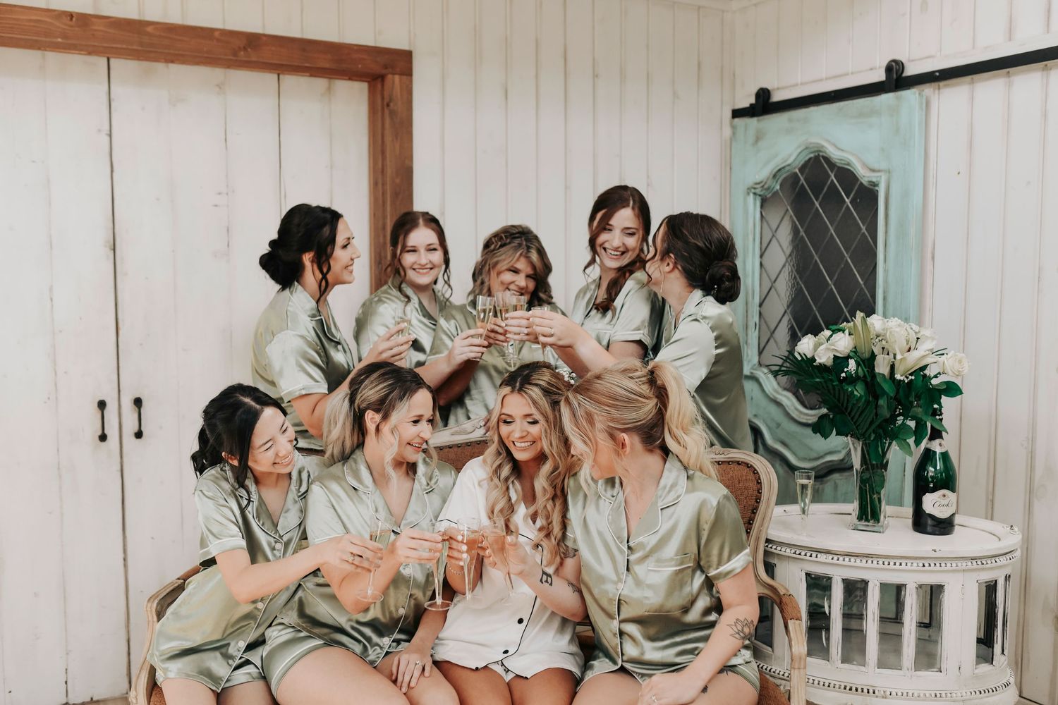 Bridesmaids popping champagne in bridal suite