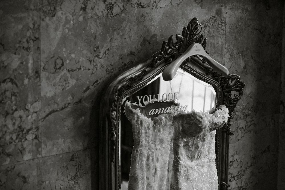 A dark and moody series of black and white photographs showing vintage clothes hangers against a textured wall.