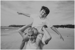 Playful beach scene with people having fun in black and white photography.