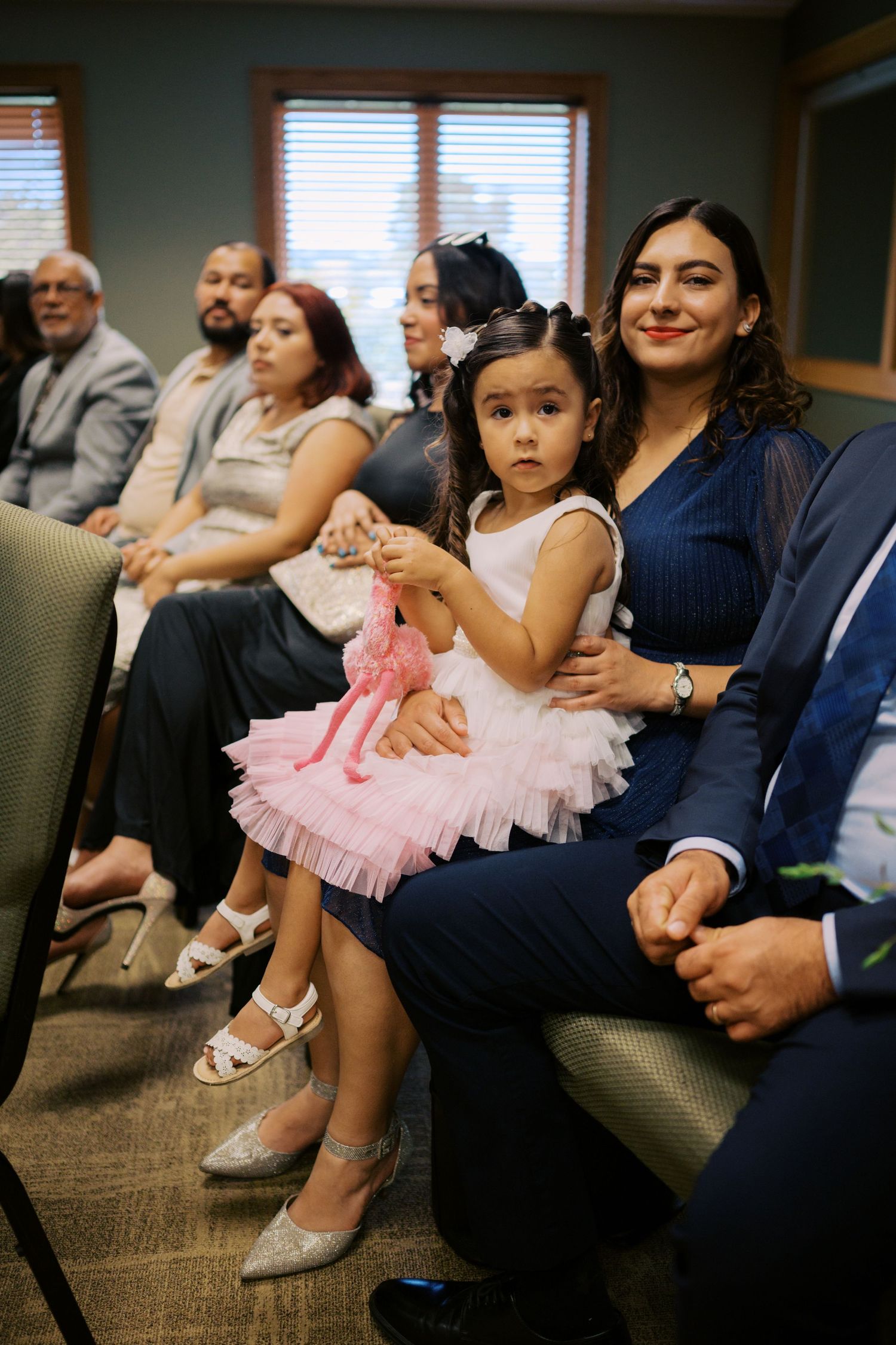 Wedding guests seated in formal attire watching the ceremony.