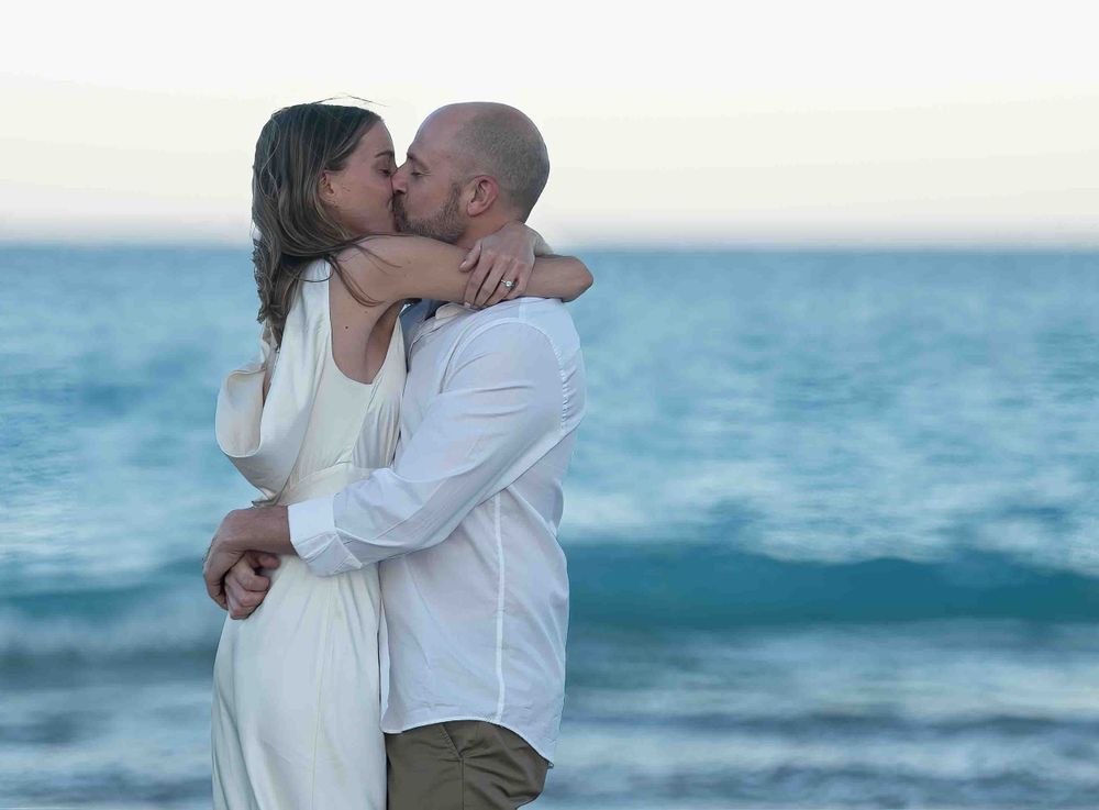 Kari and Jeff kissing passionately on the beach at Worth Ave