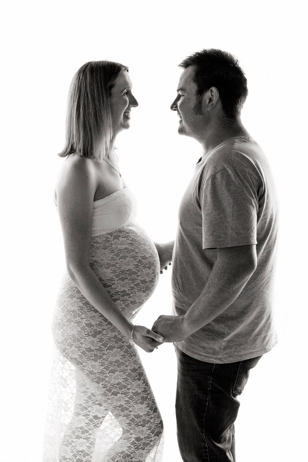 Maternity Photography Melbourne, black and white maternity photo series showing a couple in silhouette facing each other.