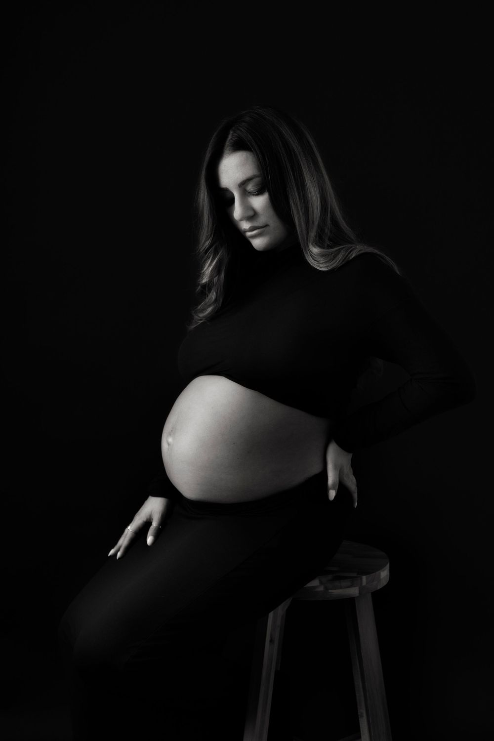 Maternity Photography Melbourne, black and white moody maternity photos showing pregnant silhouette in black dress.