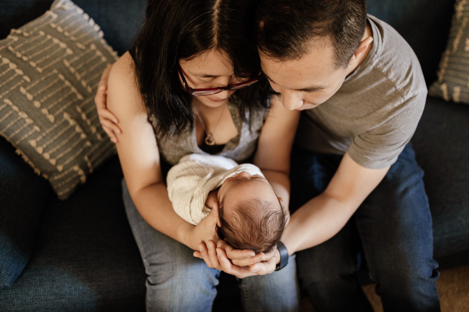 Proud parents holding baby on their soft - Bay Area lifestyle photographer