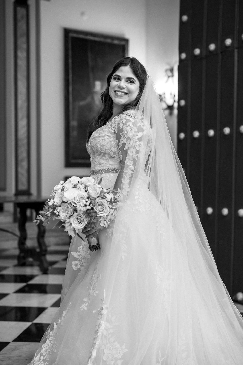 Black and white wedding photo series showing elegant bridal poses with flowing white gown and detailed floral bouquet.