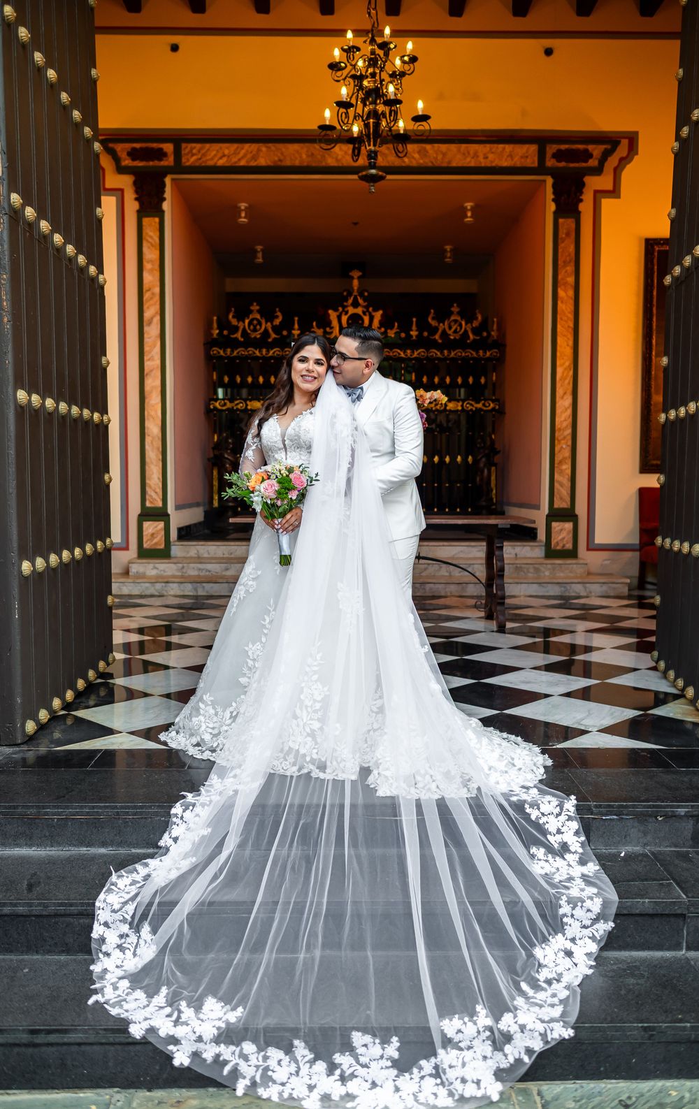 Elegant bridal veil with intricate lace appliques sweeps across a black and white checkered floor in multiple views.