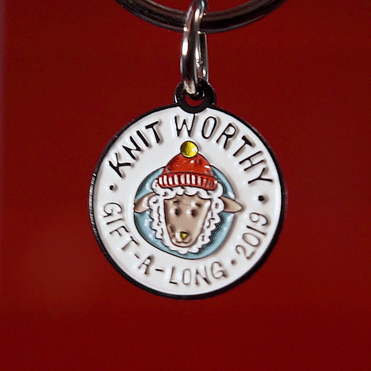 Handmade ceramic pendant necklaces with winter-themed designs including knitted hats on red background.