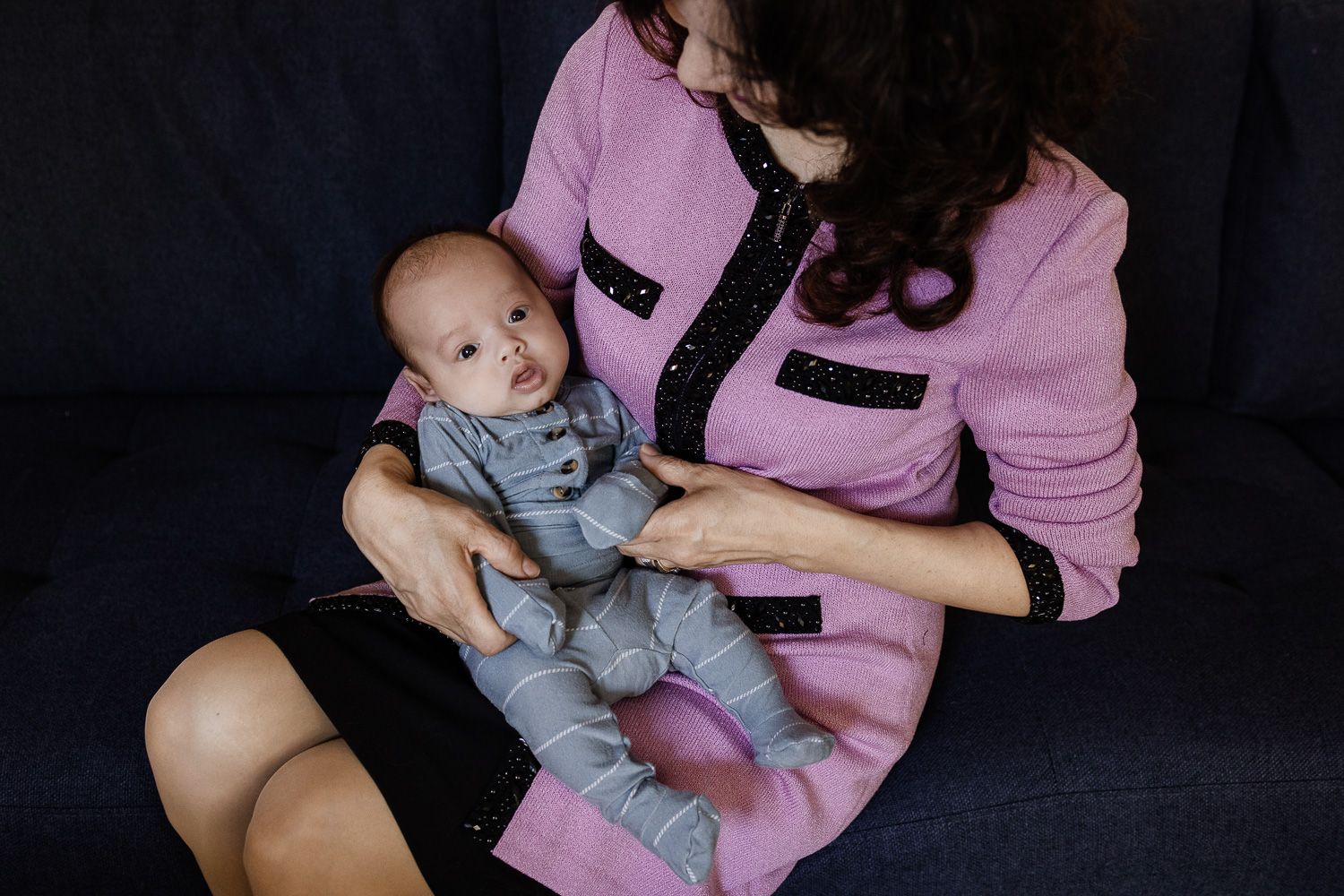 A grandma cuddles her new grand baby at his photo session